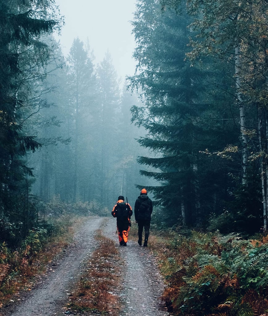 Hunters walking down trail in orange